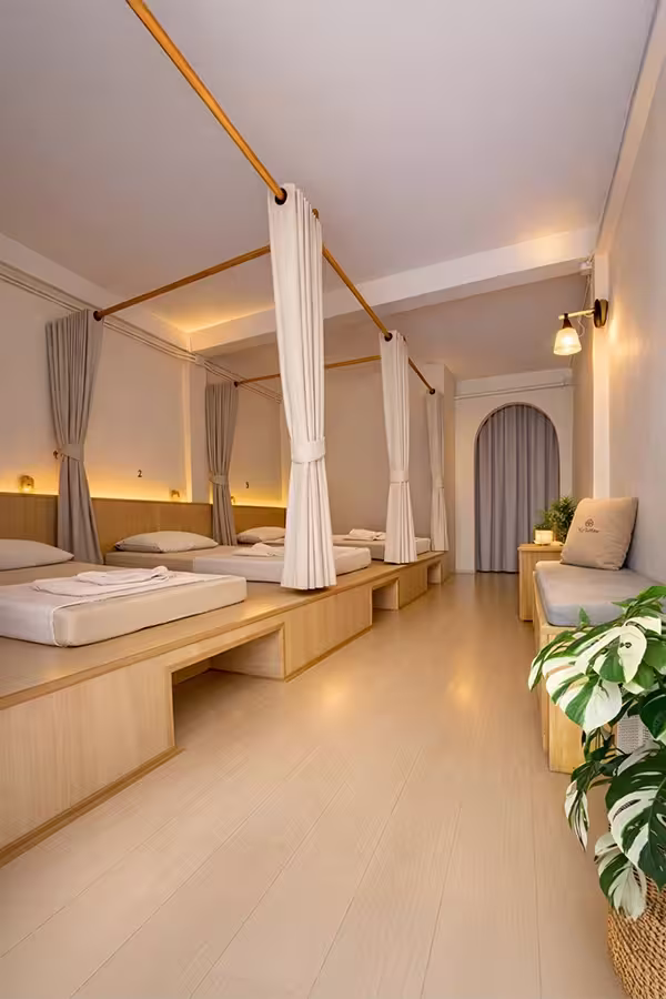 Spacious treatment room with several massage beds